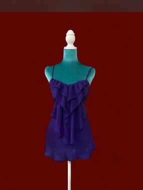 Y2K babydoll cami top in a rich purple shade featuring cascading ruffles, adjust